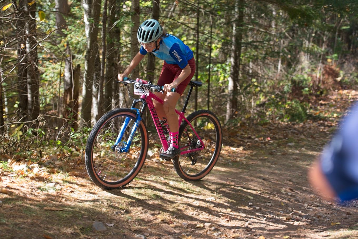 A Tonka rider descending on a pink mountain bike